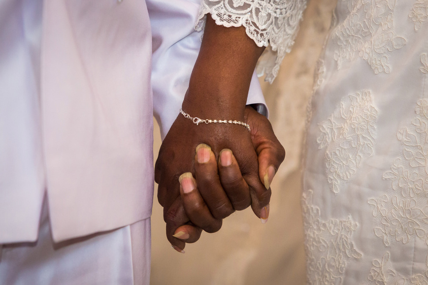 Black Couple Holding Hands during Marriage